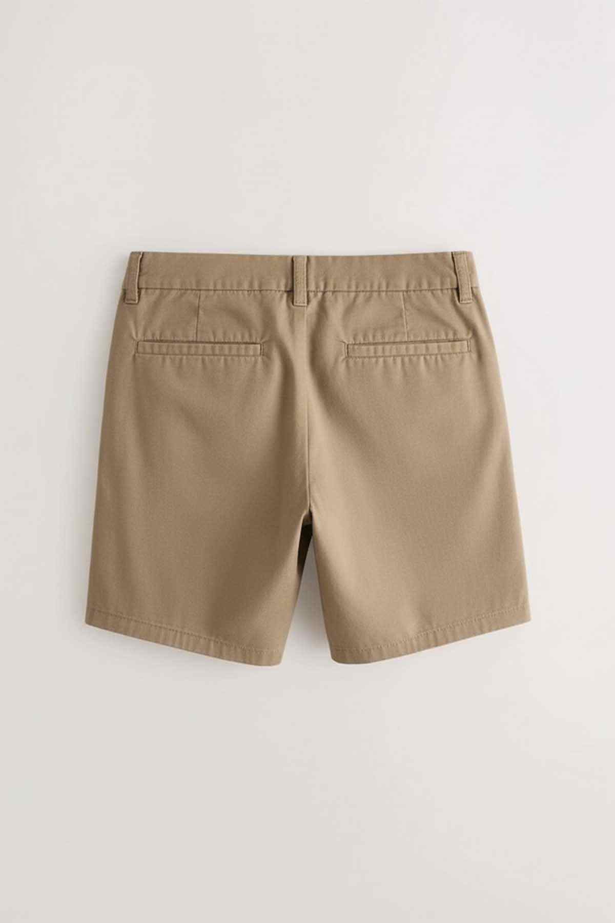 Beige kids shorts with pleated front, belt loops, and back welt pockets