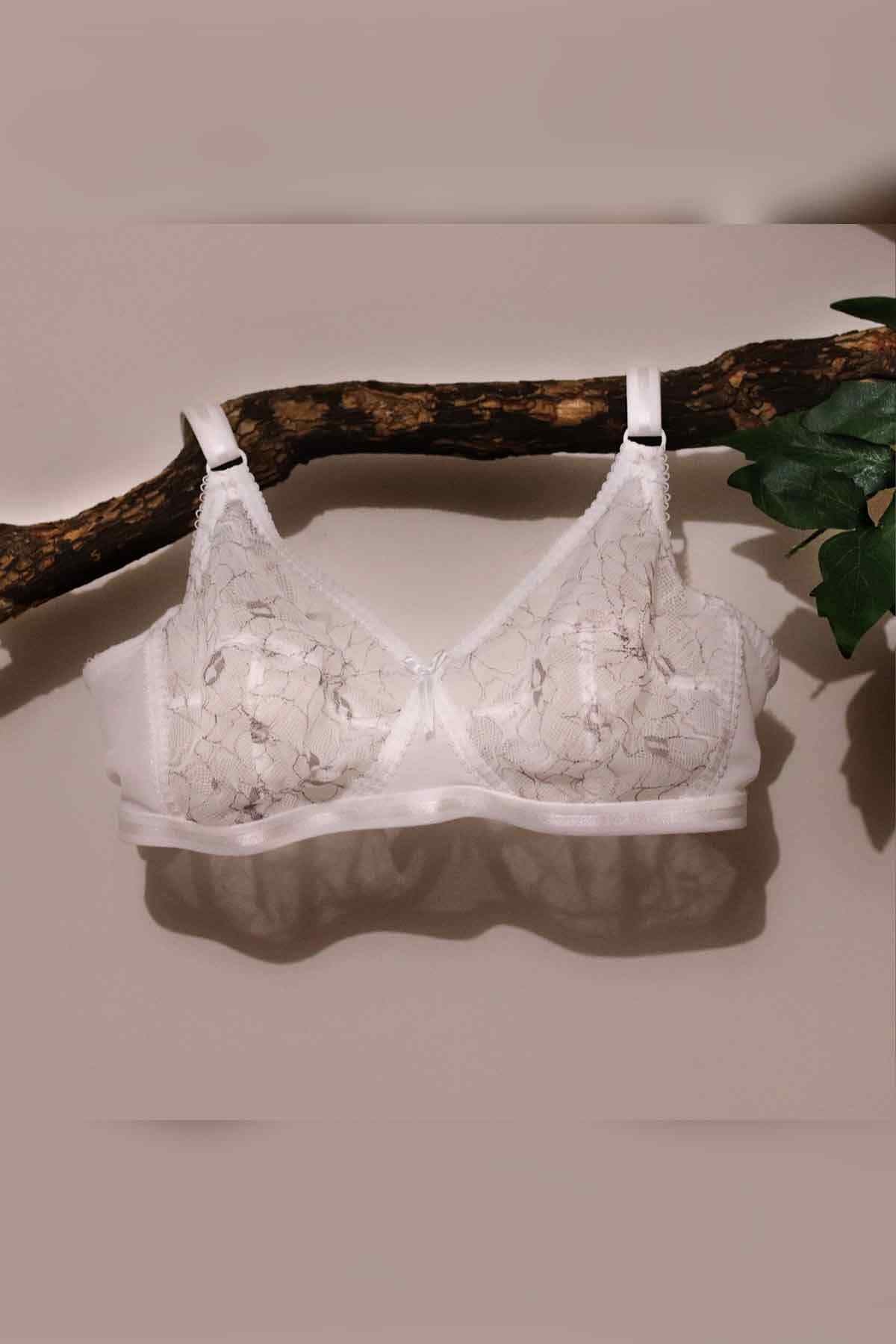 White lace underwire bra laid flat, showing adjustable straps