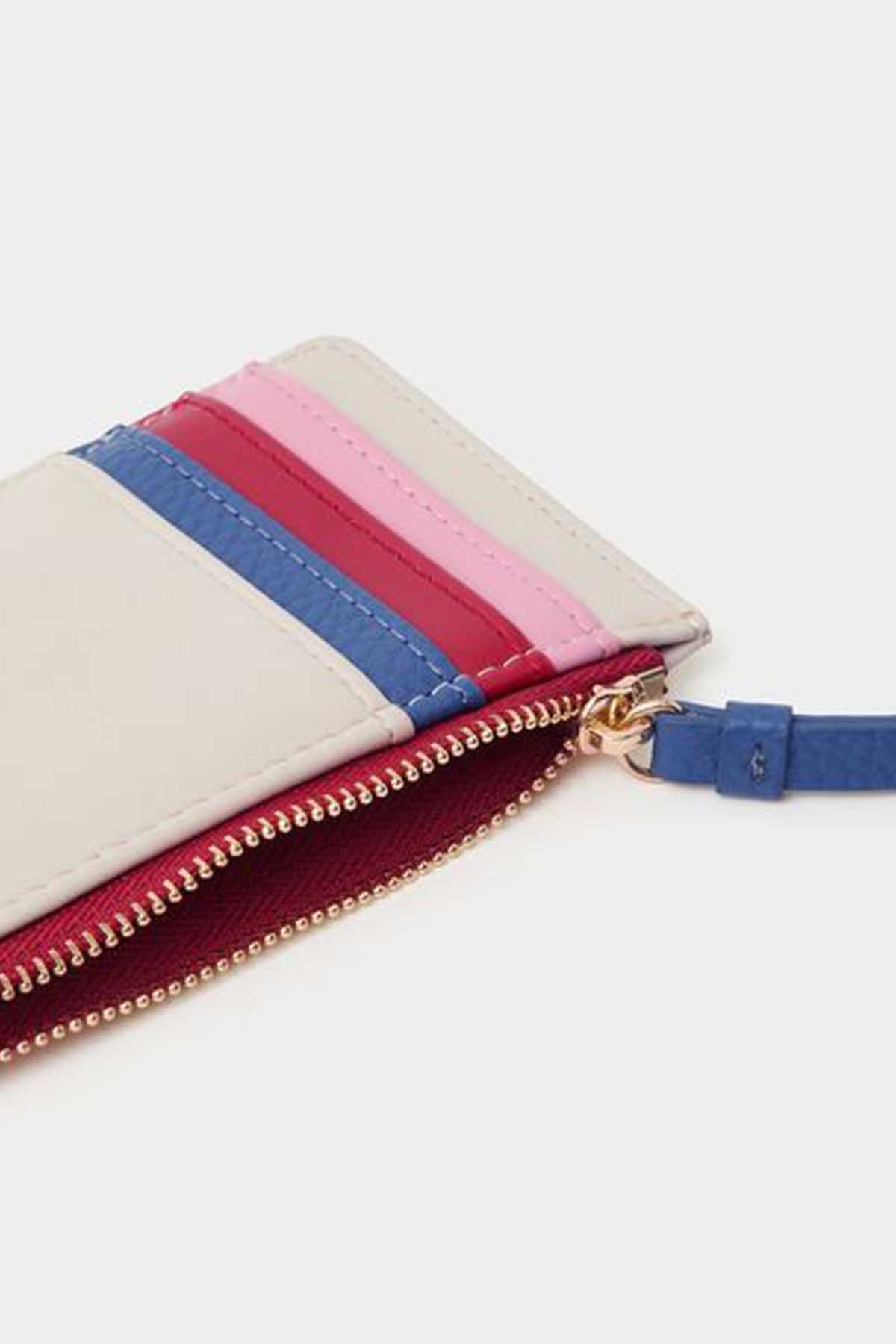 Close-up of mini clutch zip with layered pink, red, blue, and cream panels