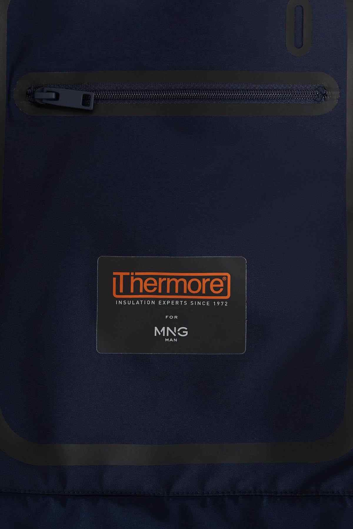 Dark blue hooded jacket panel with Thermore logo and visible zipper