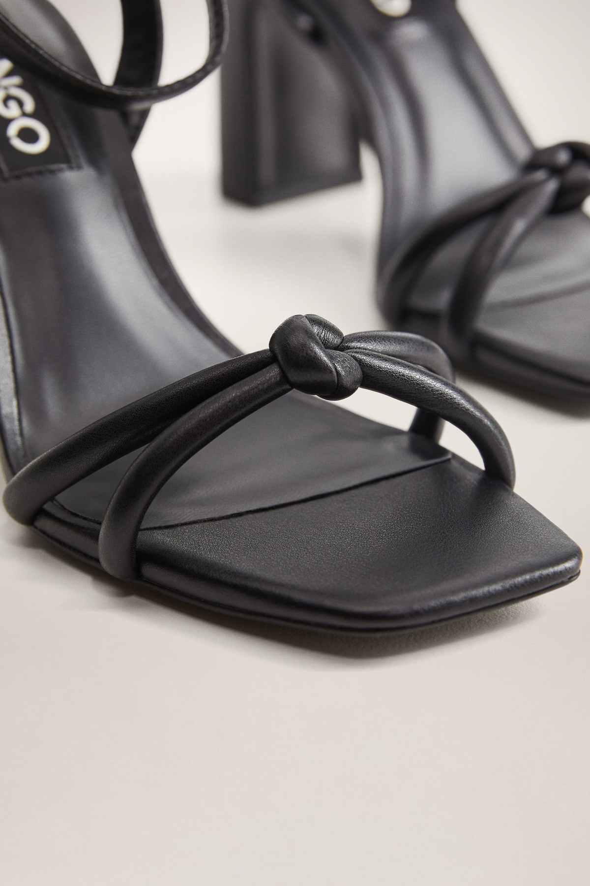 MANGO black heeled sandal close-up, knotted strap across open toe