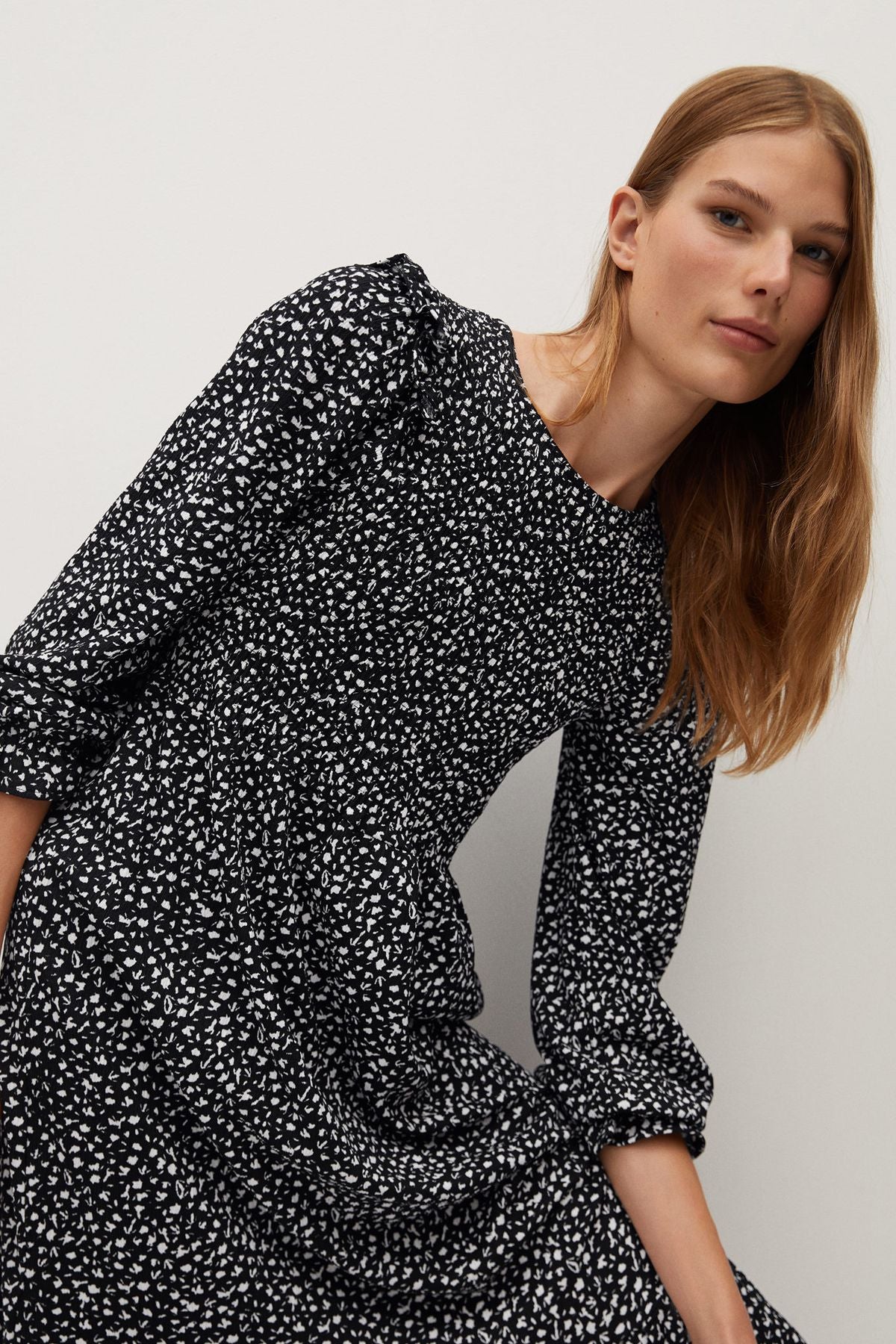 Black printed long-sleeve dress with gathered shoulders and ruched cuff