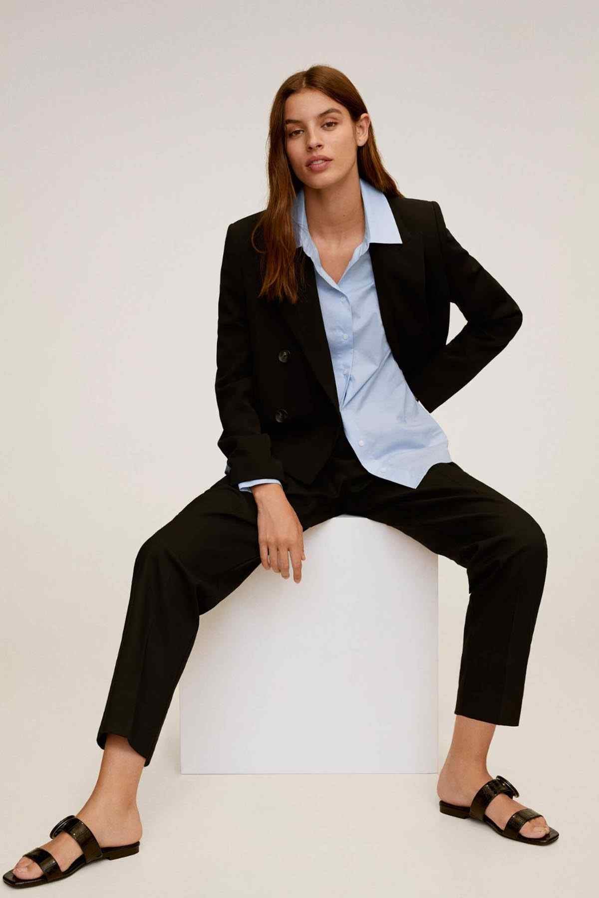 Sky blue button-up shirt worn under a black blazer, open collar