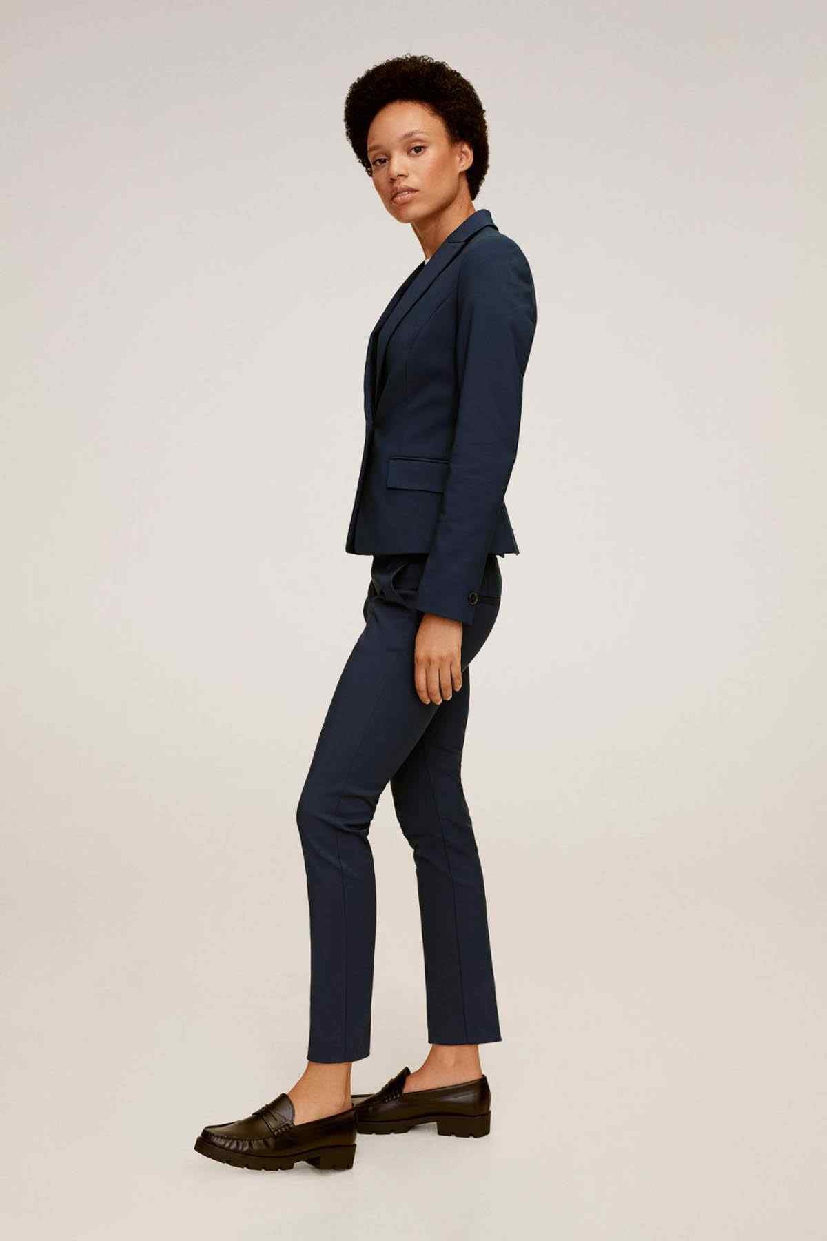 MANGO navy tailored trousers, side view with tapered legs and ankle hem