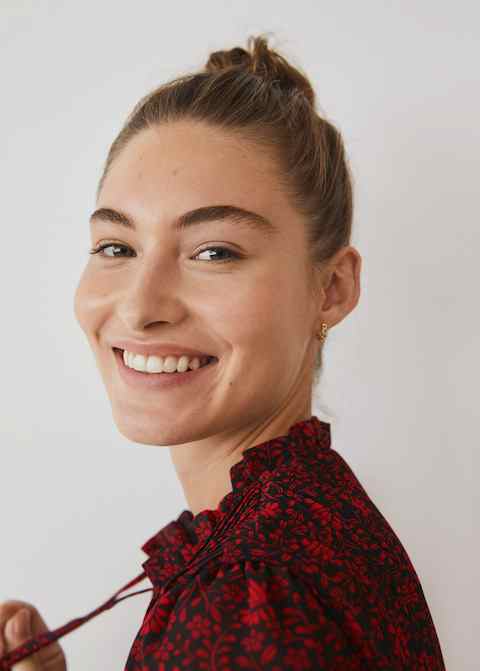 Red and dark patterned blouse with neck tie and button placket