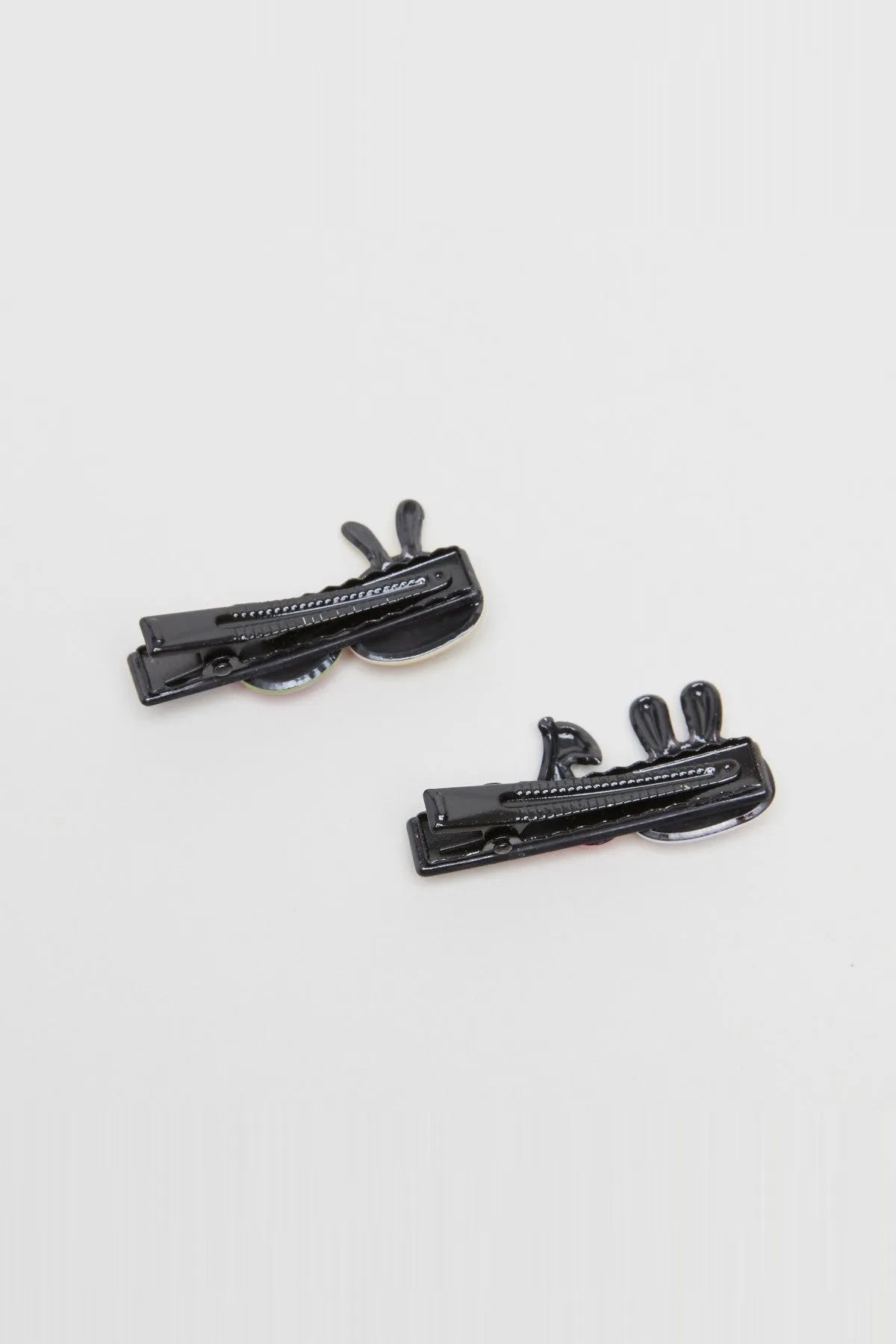 Black cartoon hair clips with animal face details on two snap clips