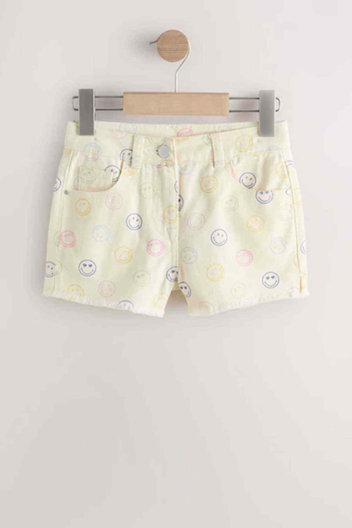 Cream printed toddler shorts with smiley pattern and elastic waistband