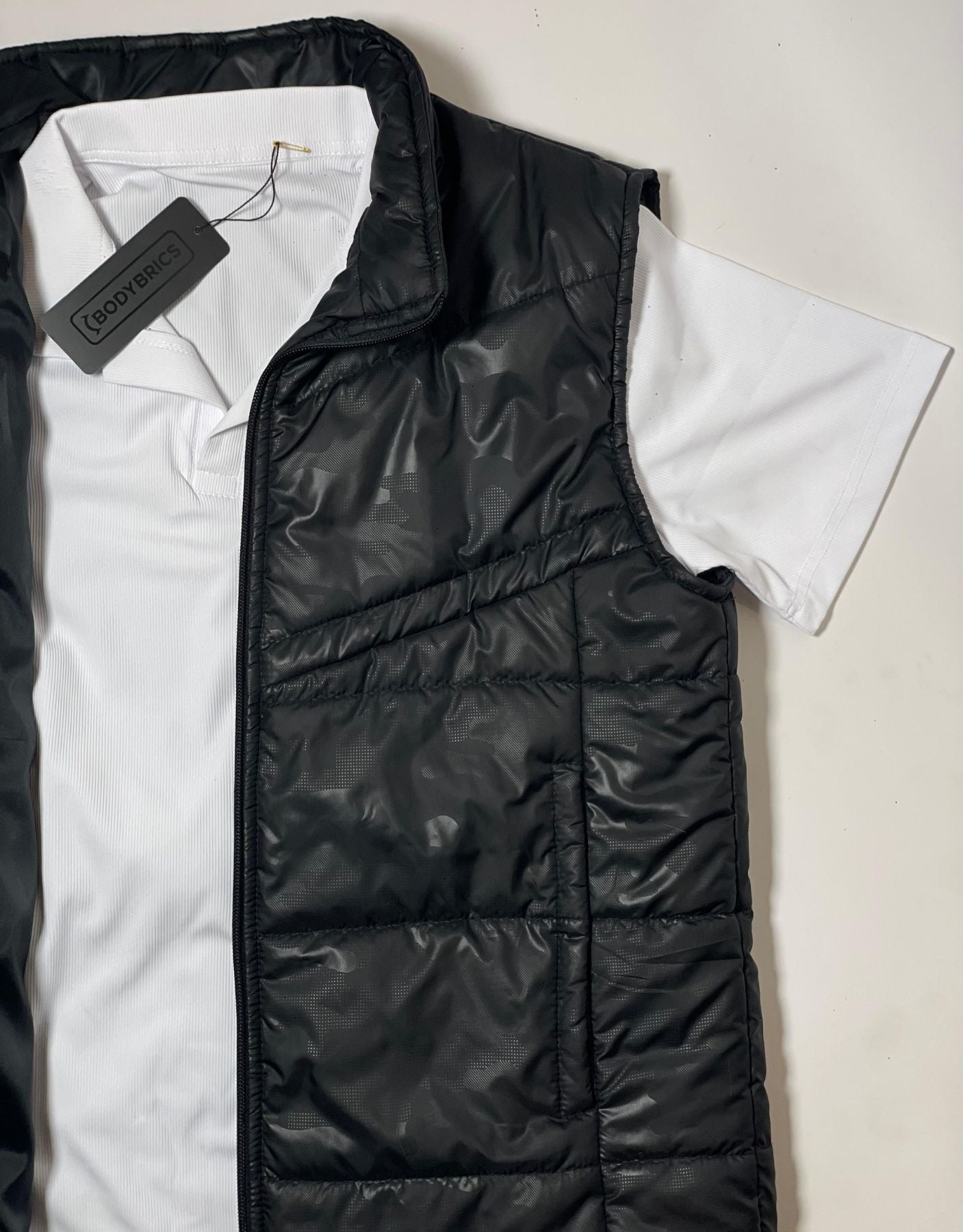 Bodybrics camo black quilted puffer vest close-up with zip front and tag