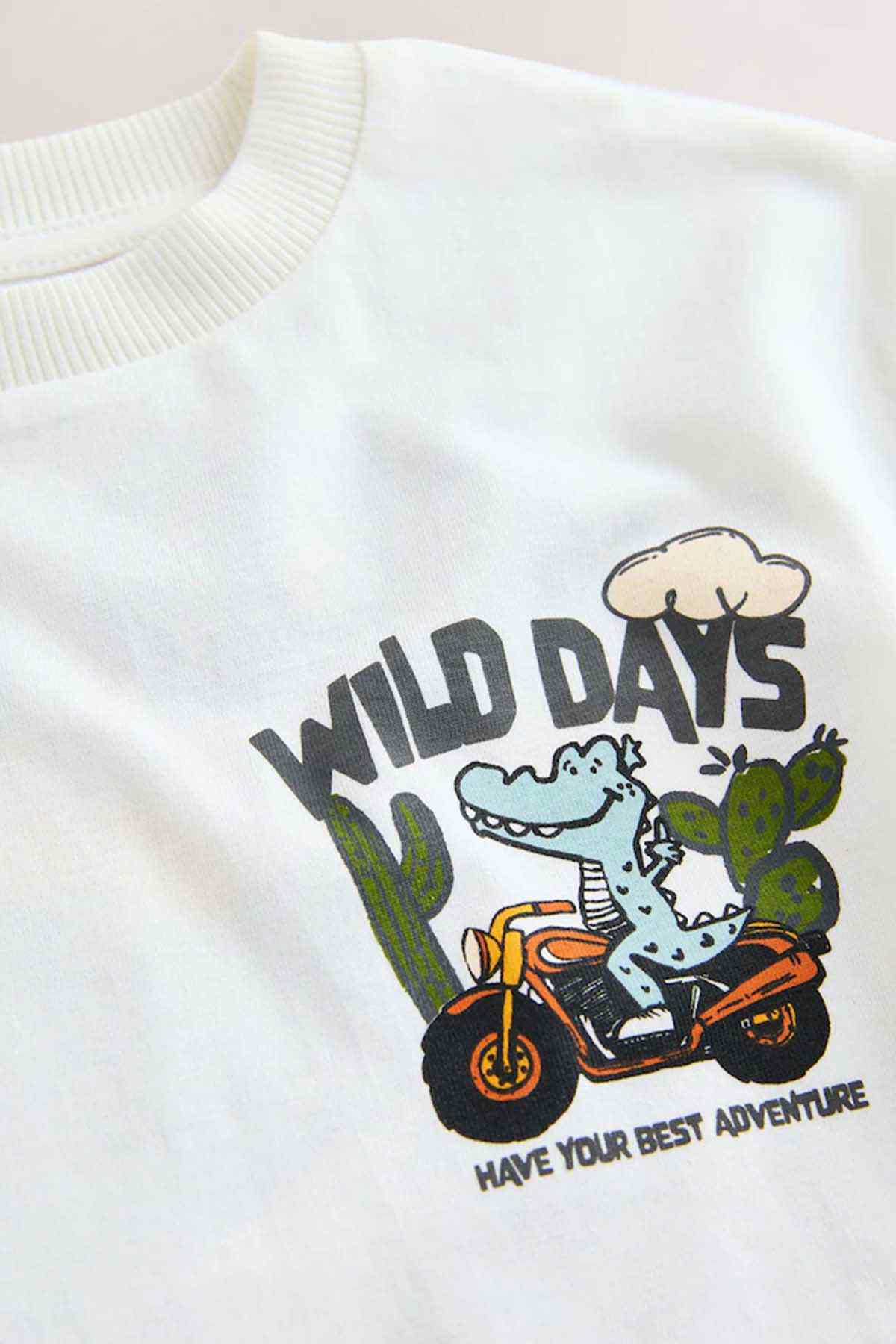 White kids T-shirt with Wild Days dinosaur riding motorcycle graphic on chest