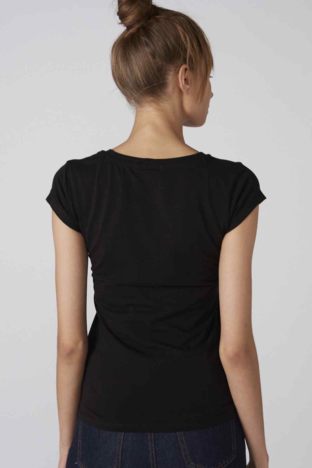 Black short-sleeve back T-shirt with dark denim jeans, no graphics visible.