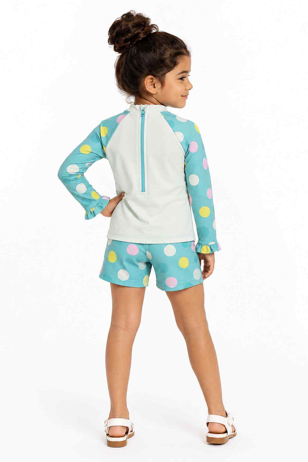 Turquoise polka-dot rash guard set with half-zip back and matching shorts, side view