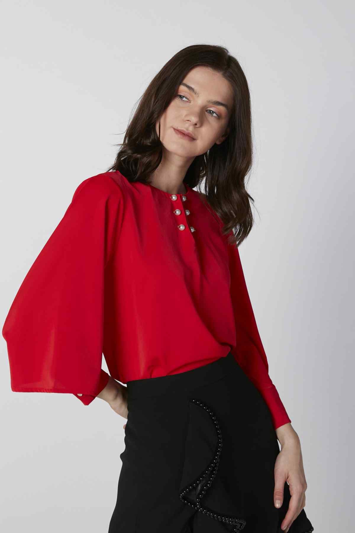 Red blouse with V-slit neckline, button placket, and wide loose sleeves