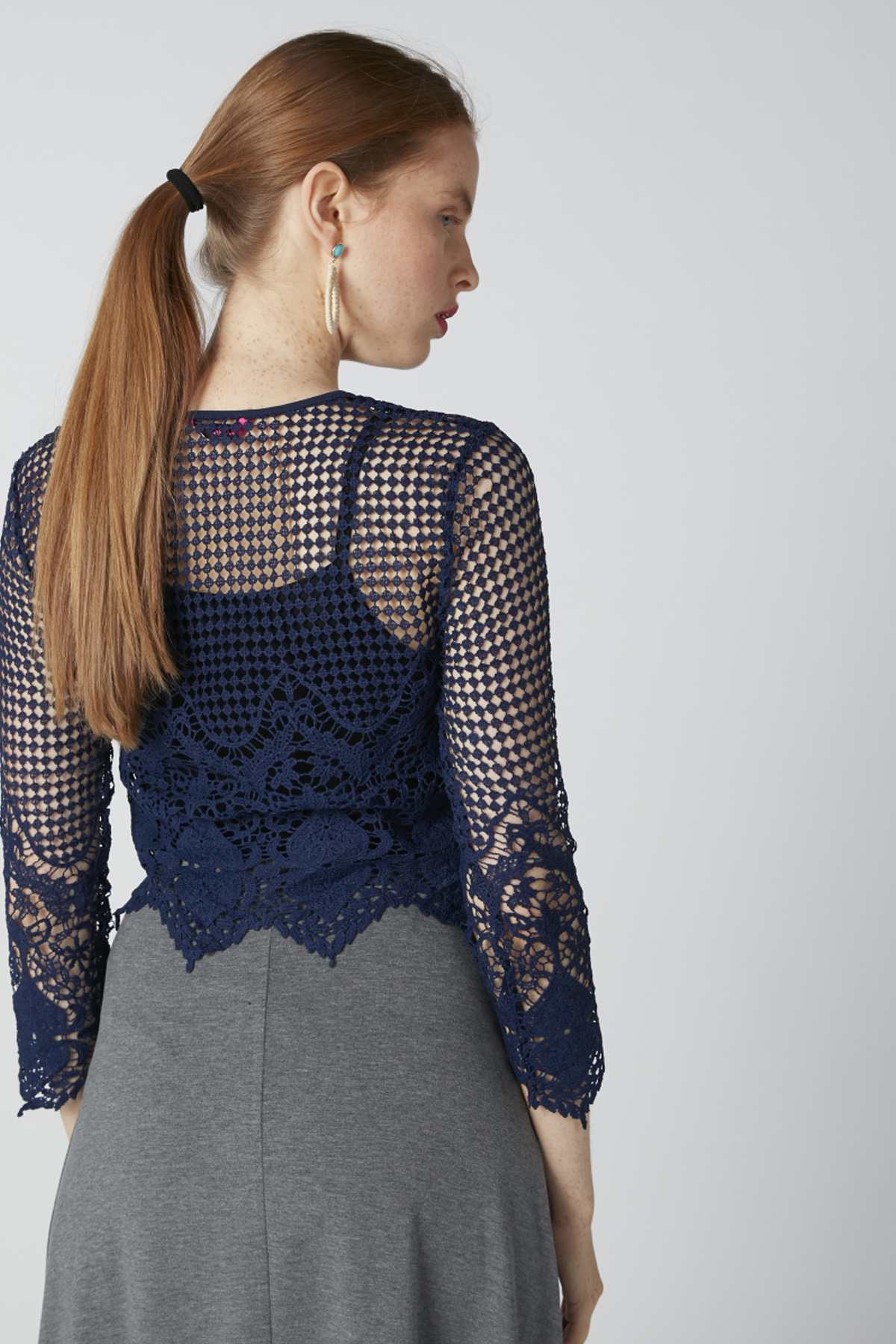 Back view: navy lace long-sleeve overlay bodice with gray midi skirt