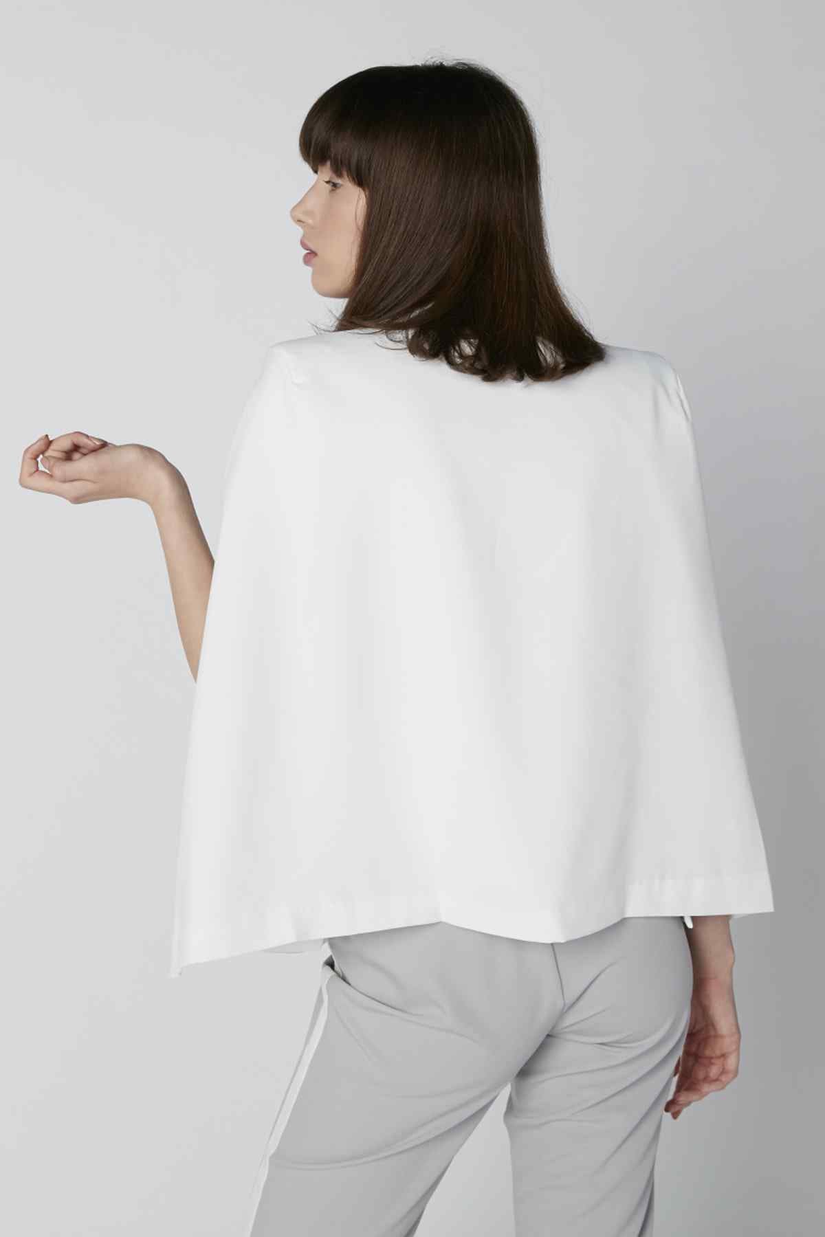 White loose T-shirt with short sleeves and flowy back drape