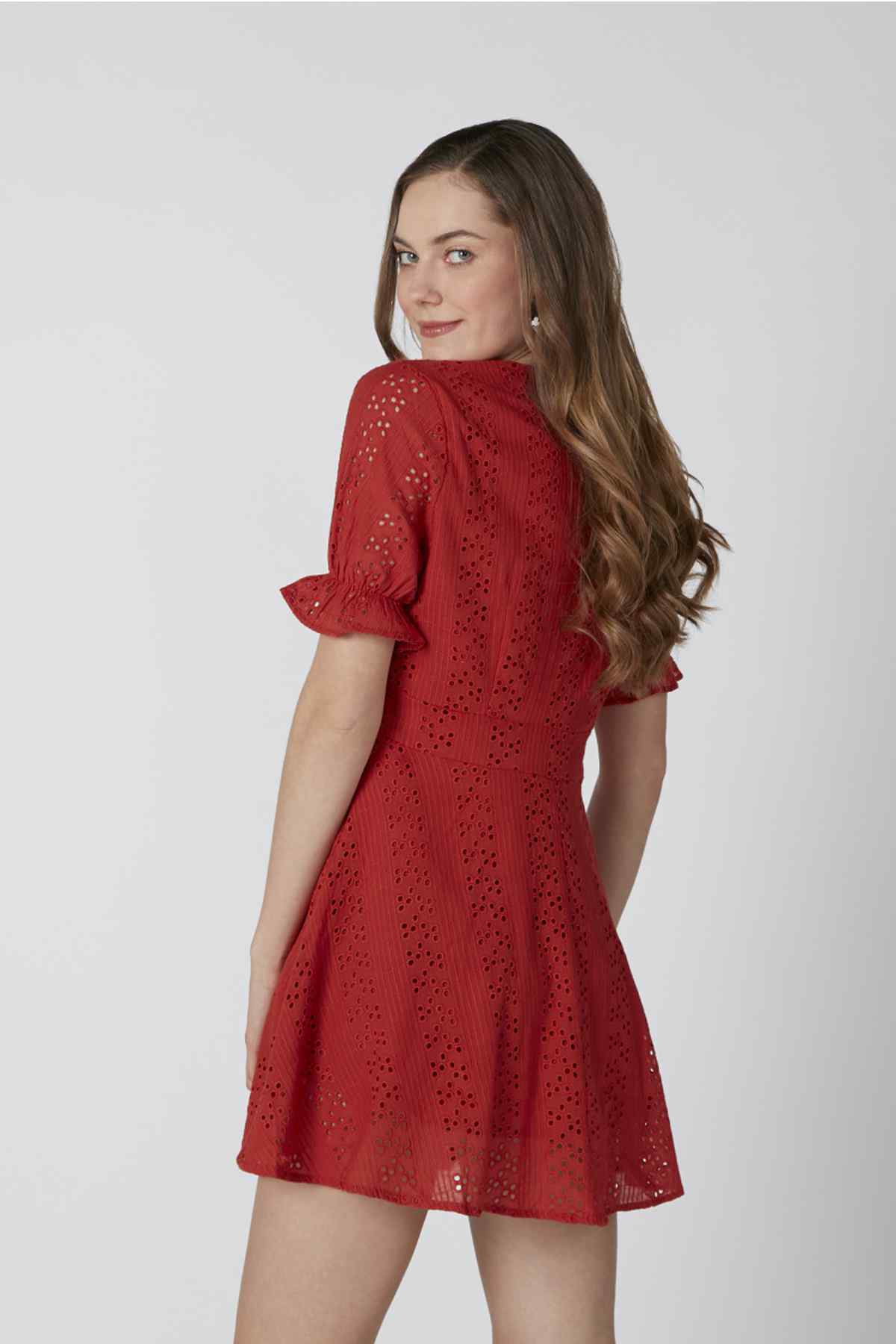 Red short-sleeve eyelet mini dress with textured pattern, back 3/4 view