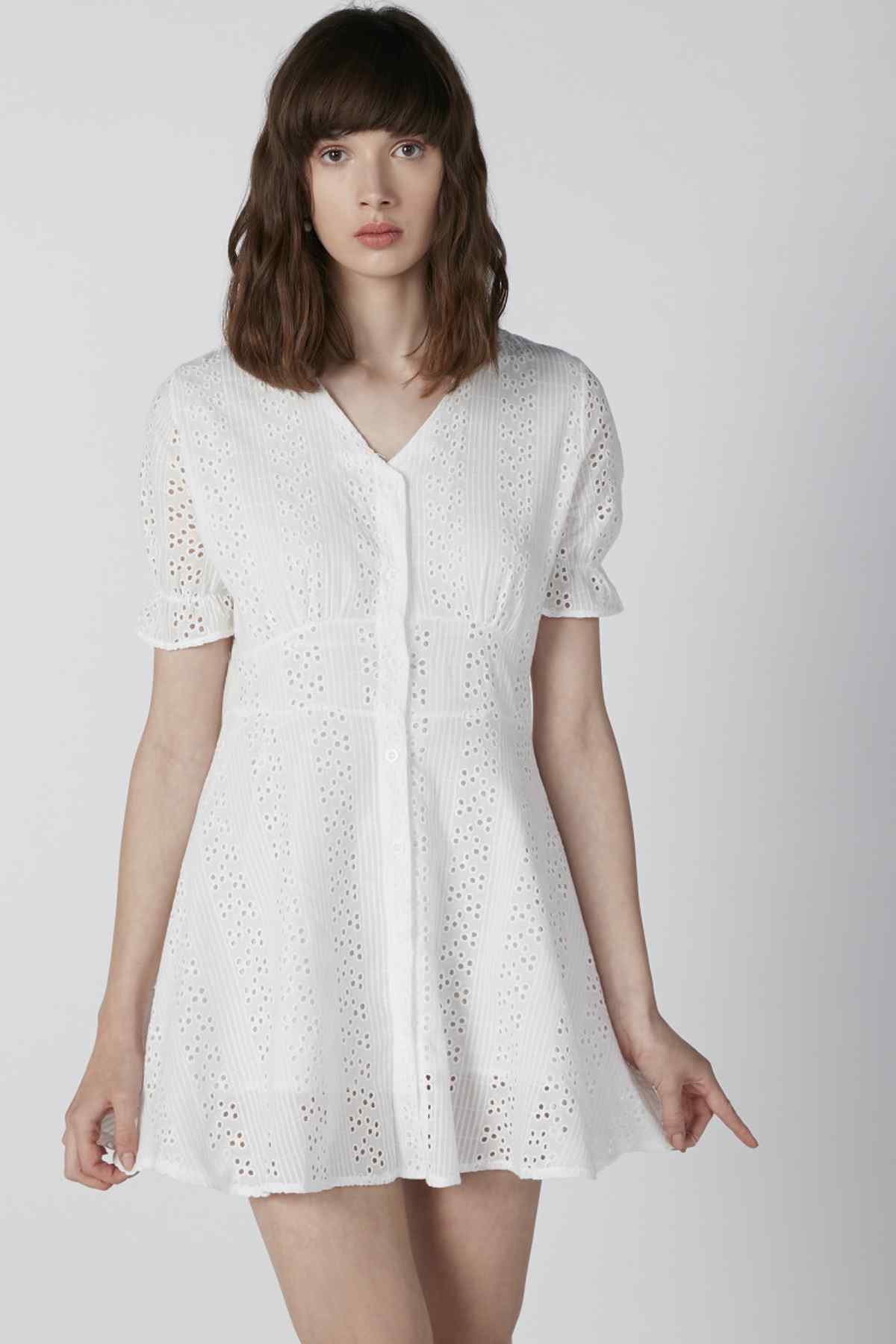 White eyelet mini dress with V-neck and short puff sleeves, relaxed fit