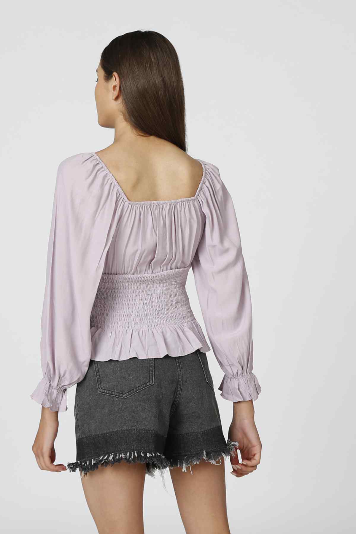 Lavender peplum blouse back view with smocked yoke and long puff sleeves