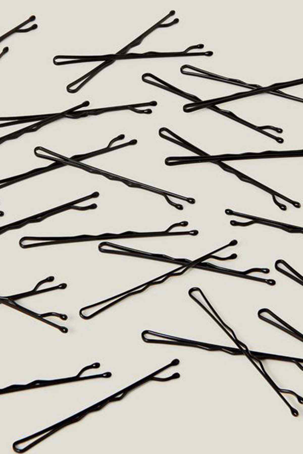 Black hair pins laid out, close-up view