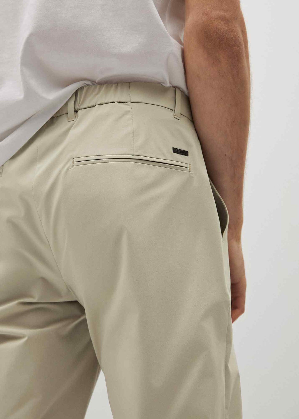 Beige chino pants with zip fly, rear welt pocket and logo tab