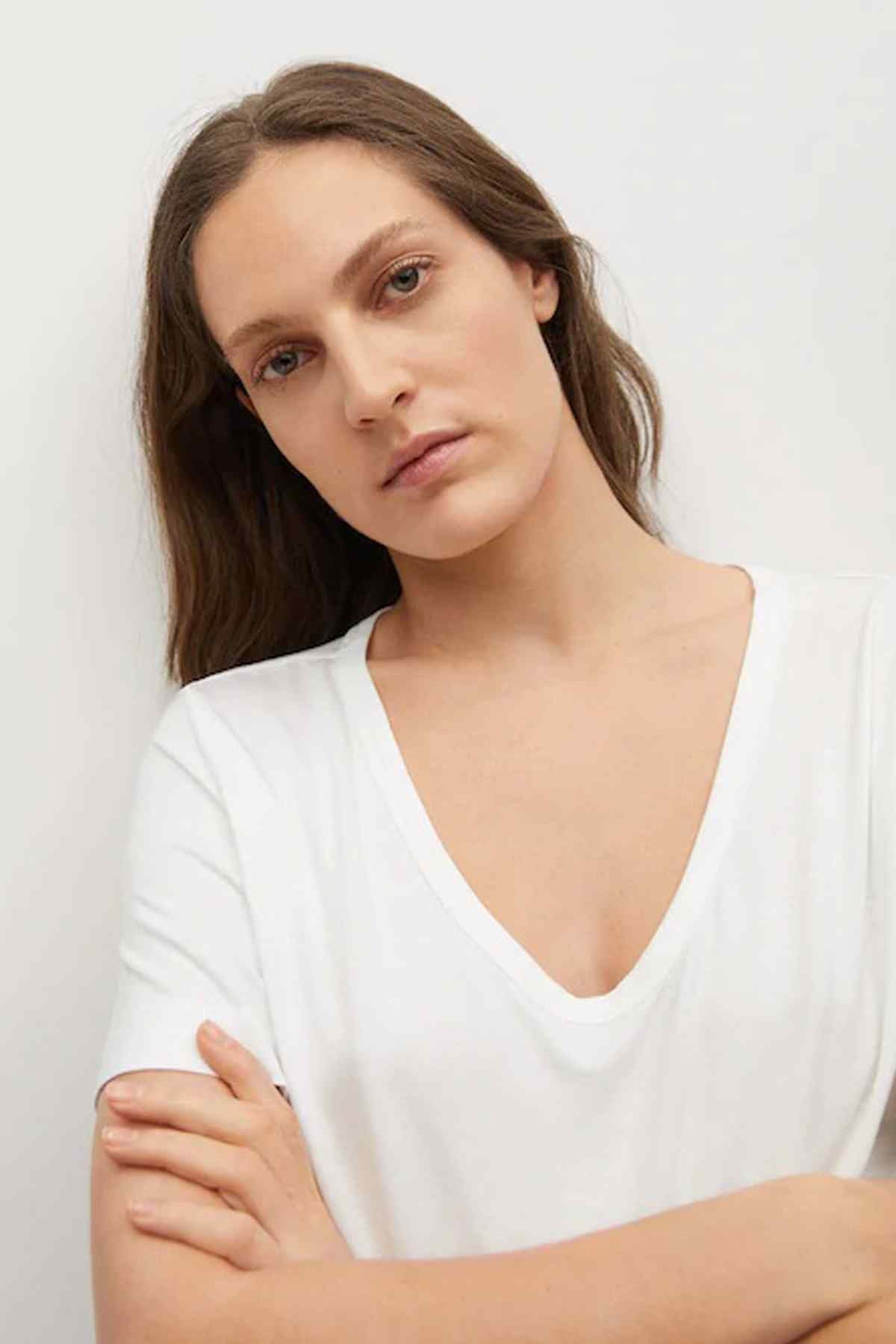 Women's white V-neck T-shirt close-up of neckline and short sleeves