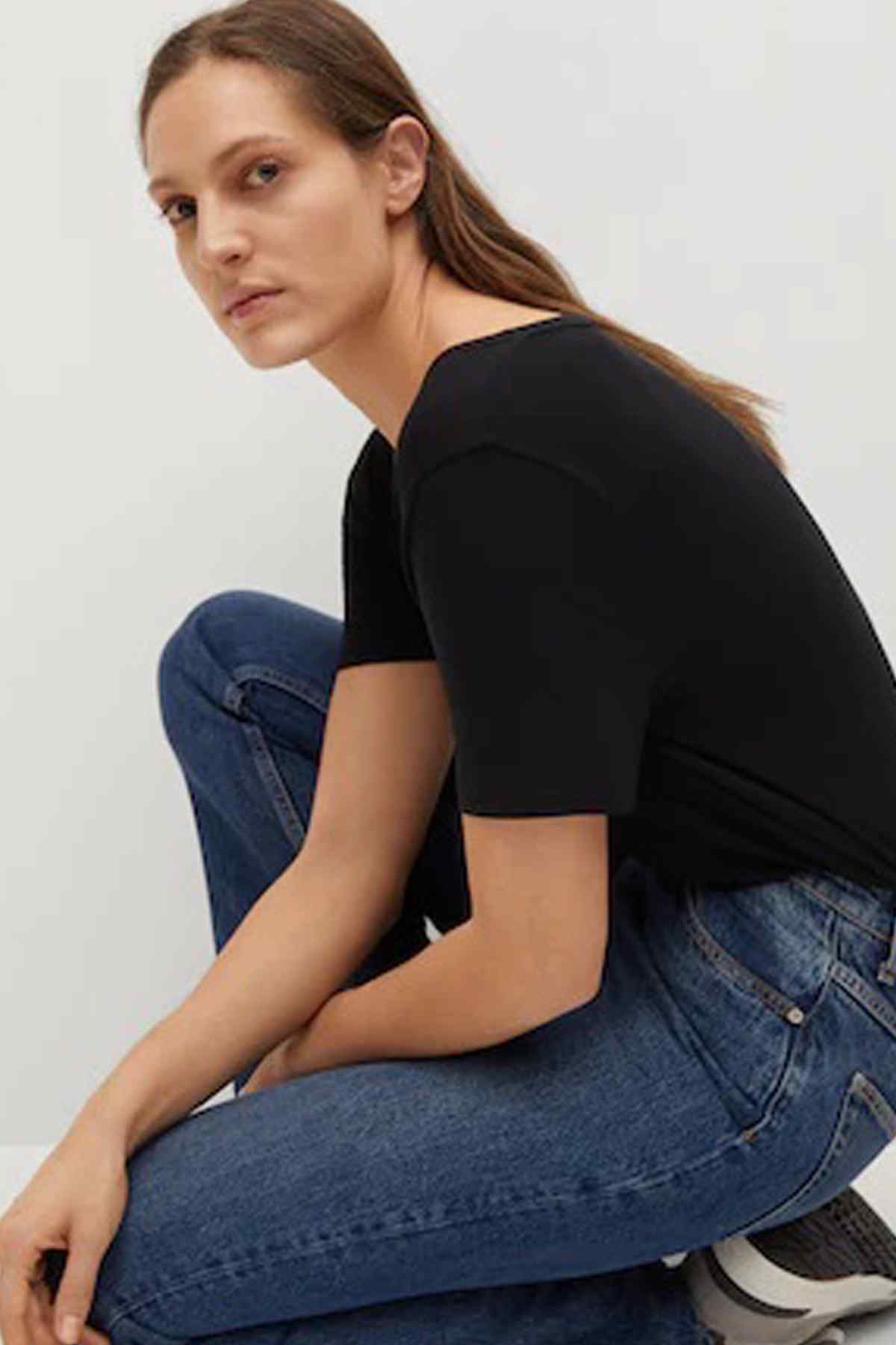 Black short-sleeve V-neck top with close-up shoulder and neckline detail