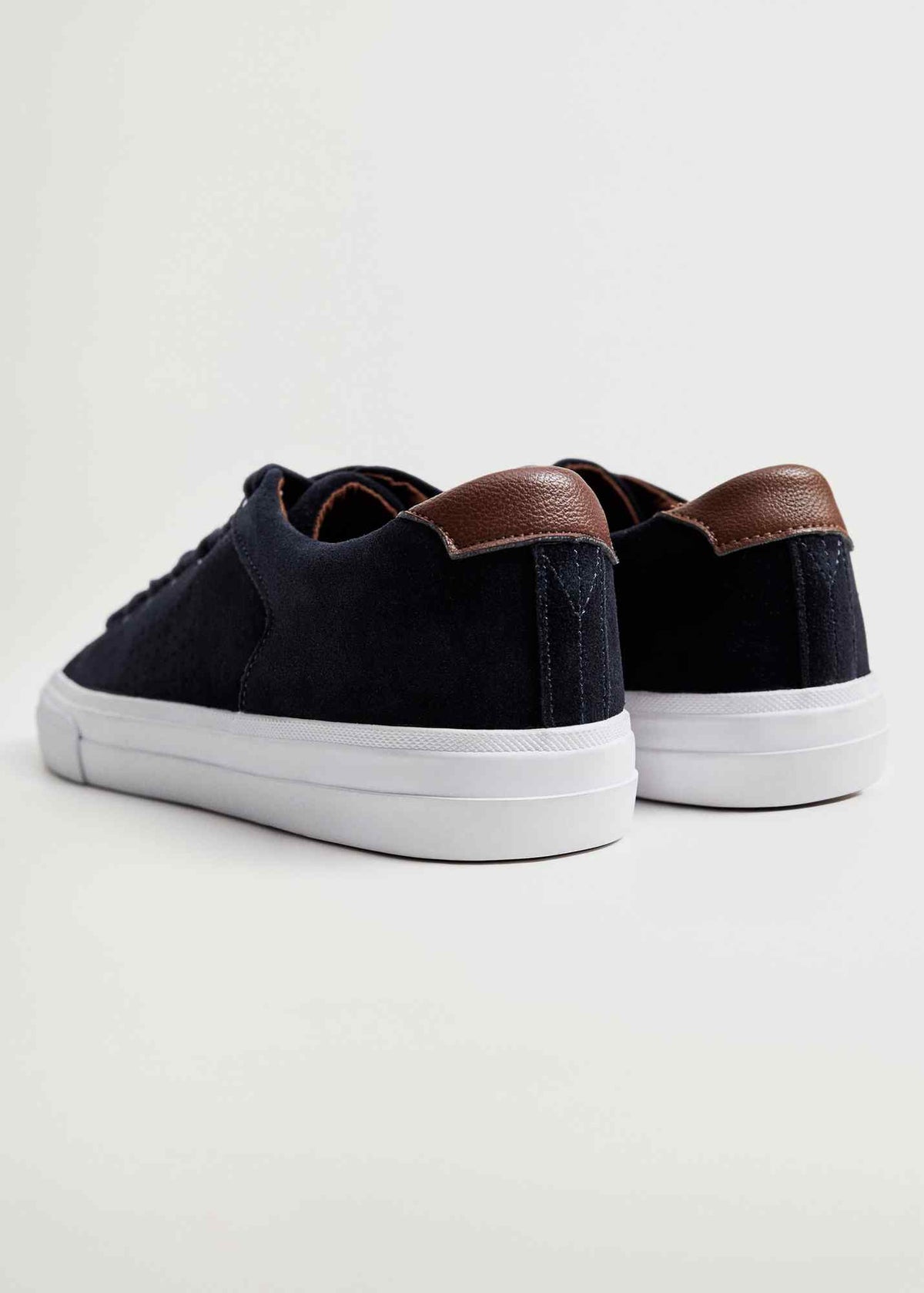 Dark navy low-top sneakers with brown heel tabs and white sidewalls