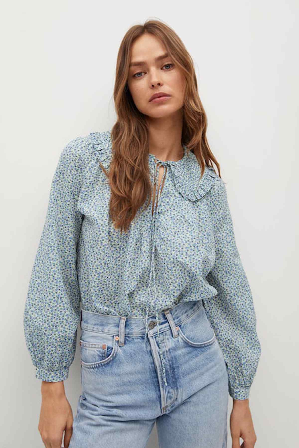 Light blue floral blouse with keyhole tie, long puff sleeves and elastic cuffs