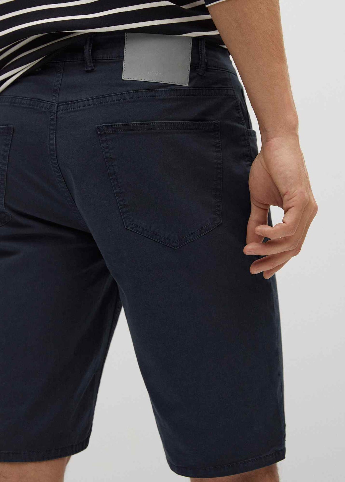 Dark navy denim shorts close-up, rear pocket and waistband