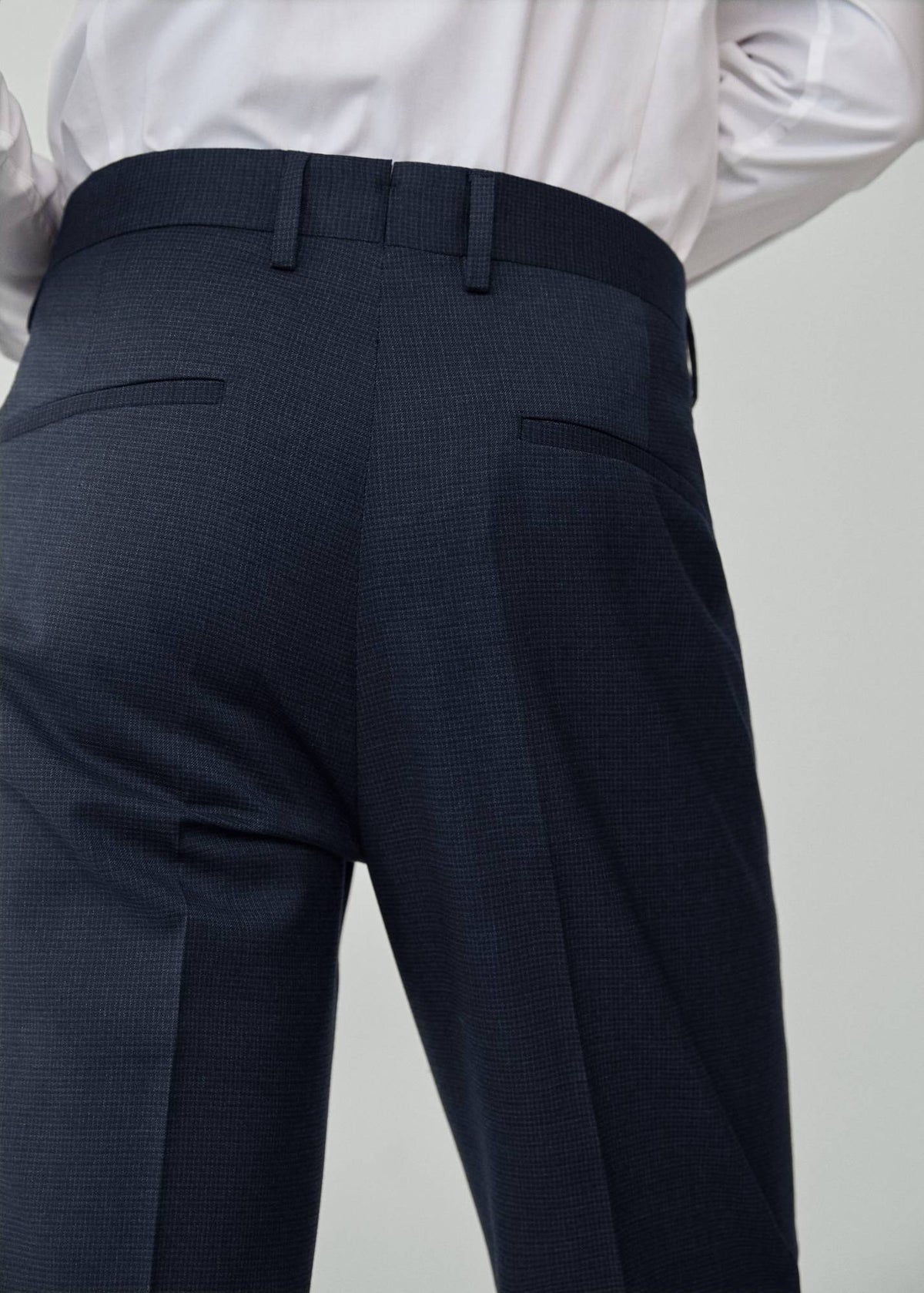 Night blue suit trousers back view with welt pockets and crease seam