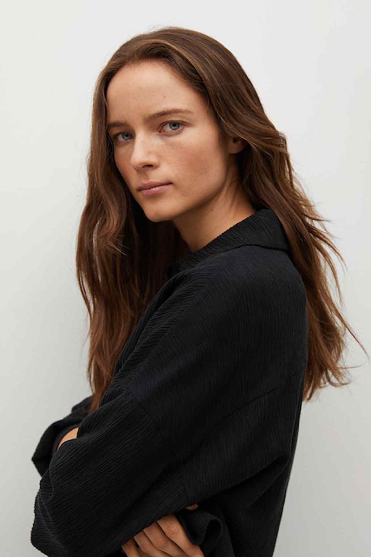 Black button-front shirt close-up on shoulder and sleeve