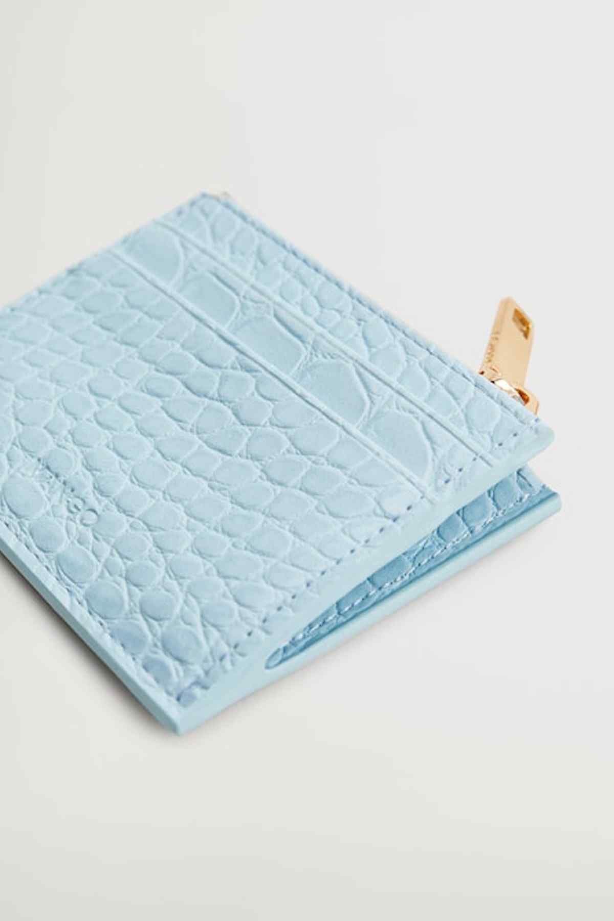 Light blue quilted pouch close-up with textured wave pattern and folded edge