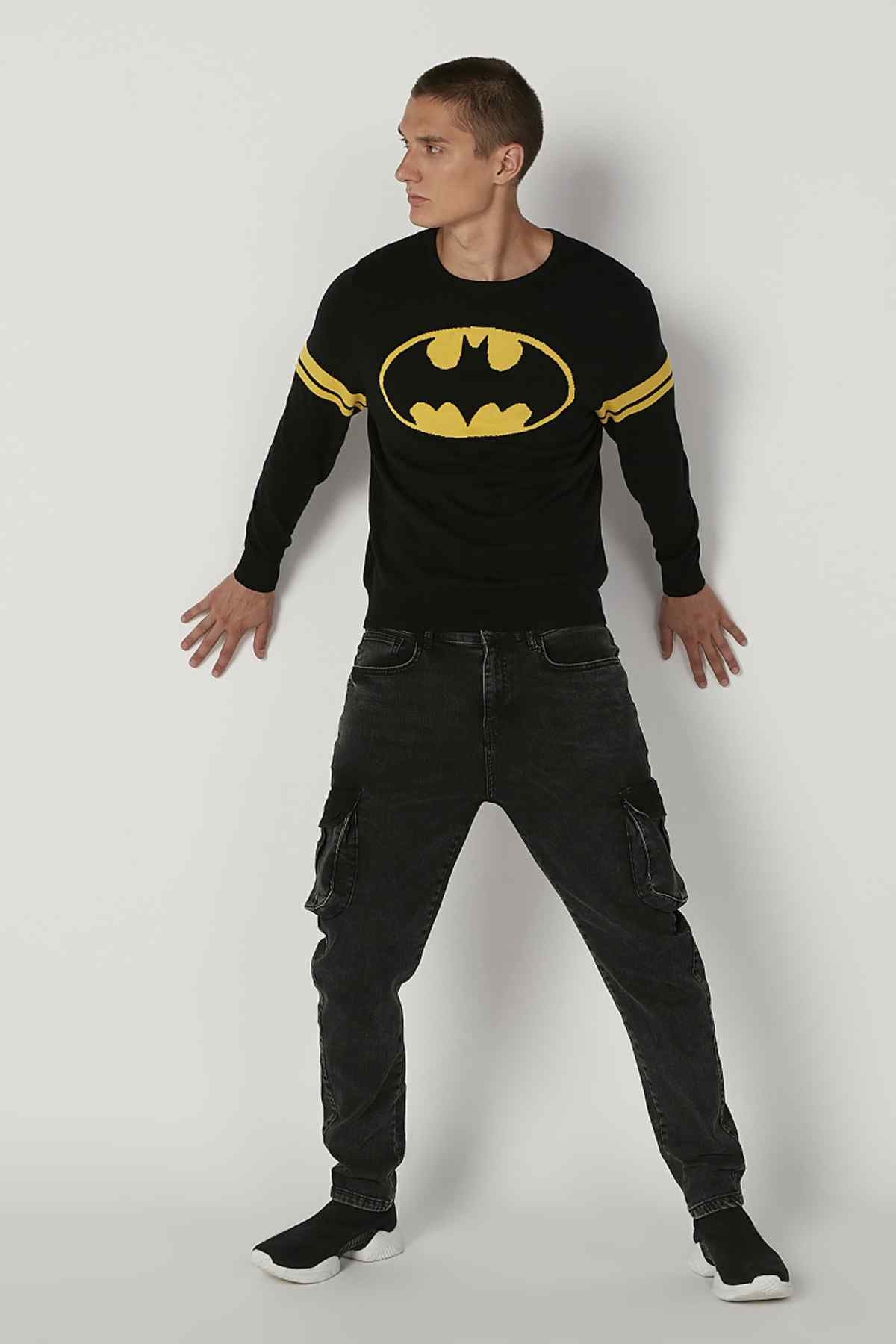 Black long-sleeve graphic sweatshirt with yellow bat logo and striped sleeve cuffs