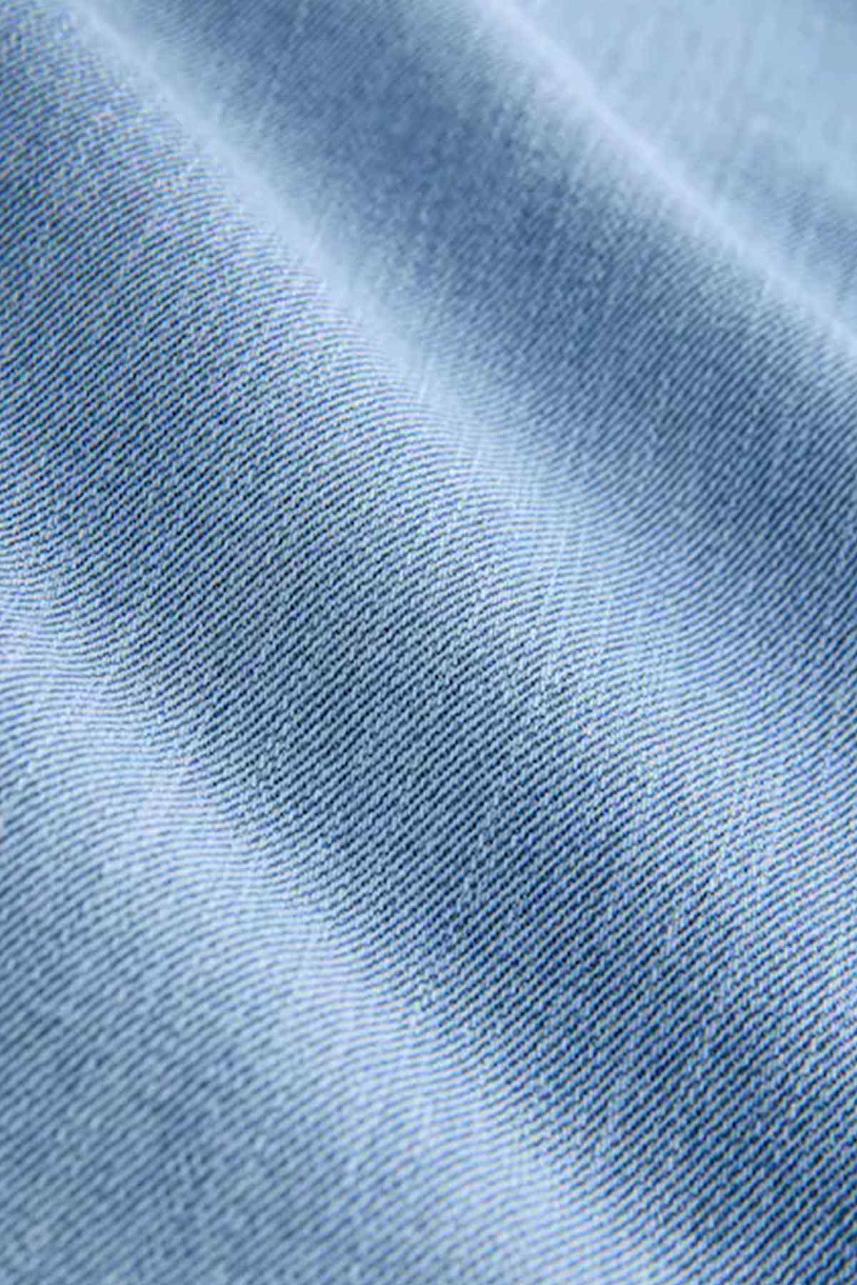 Light blue denim fabric close-up showing fine woven texture