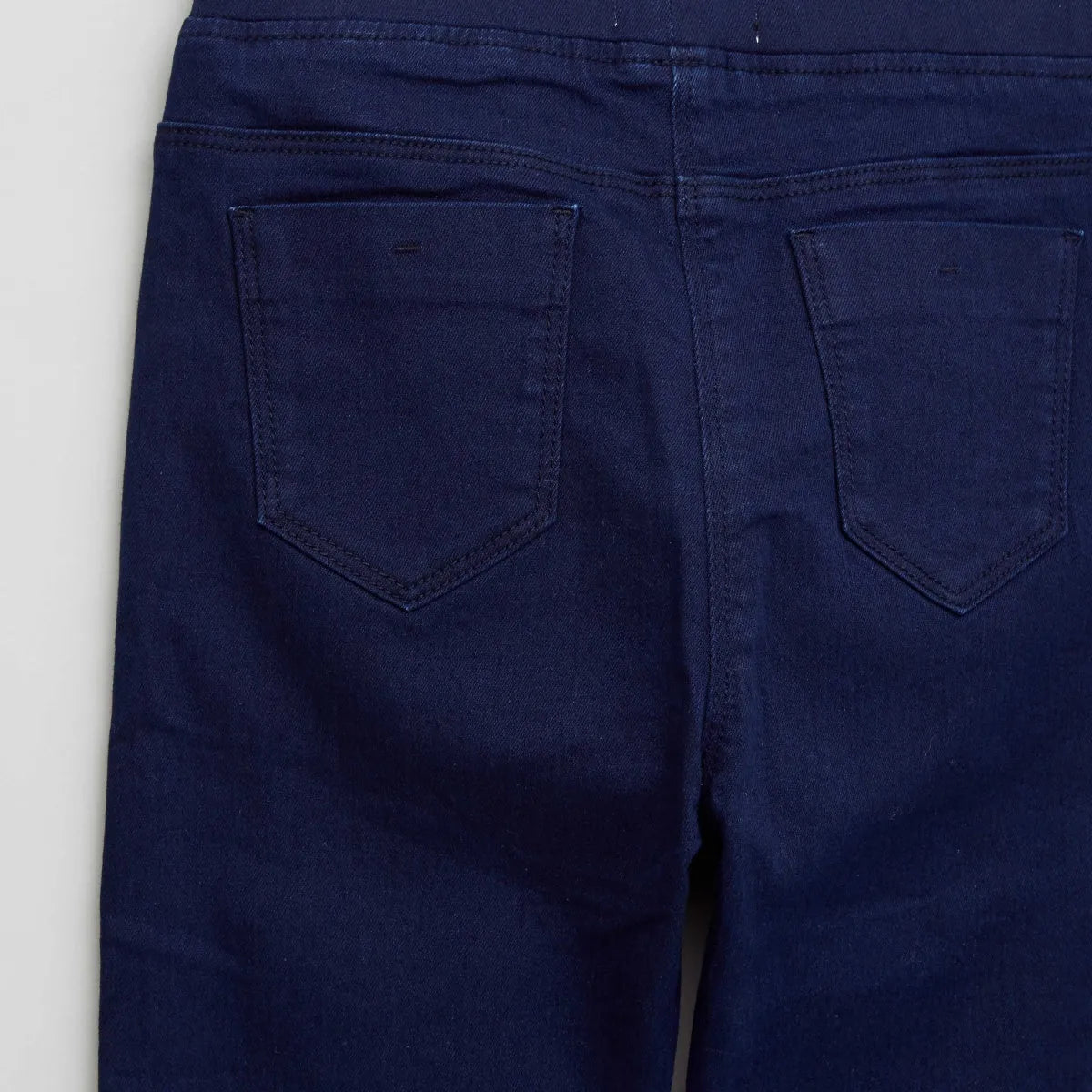 Baby jeans back view: dark blue denim with two rear patch pockets