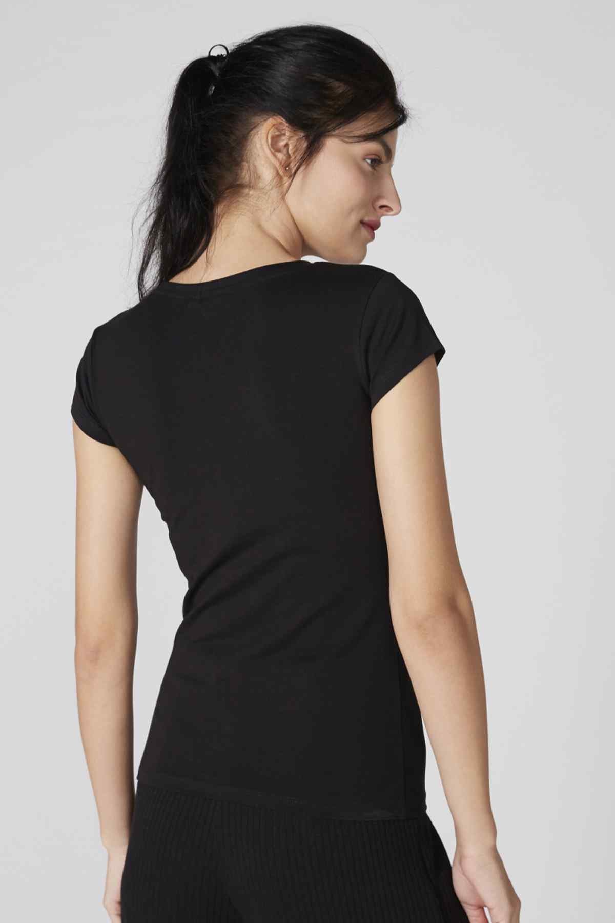 Black short-sleeve jumpsuit back view with ribbed fabric and tapered legs