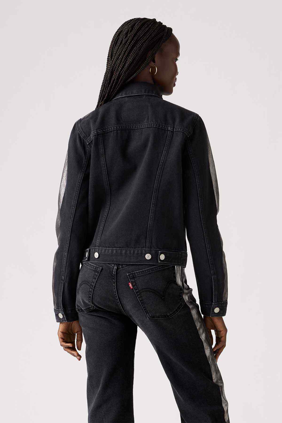 Black denim jacket, back view with seam details and buttoned cuffs