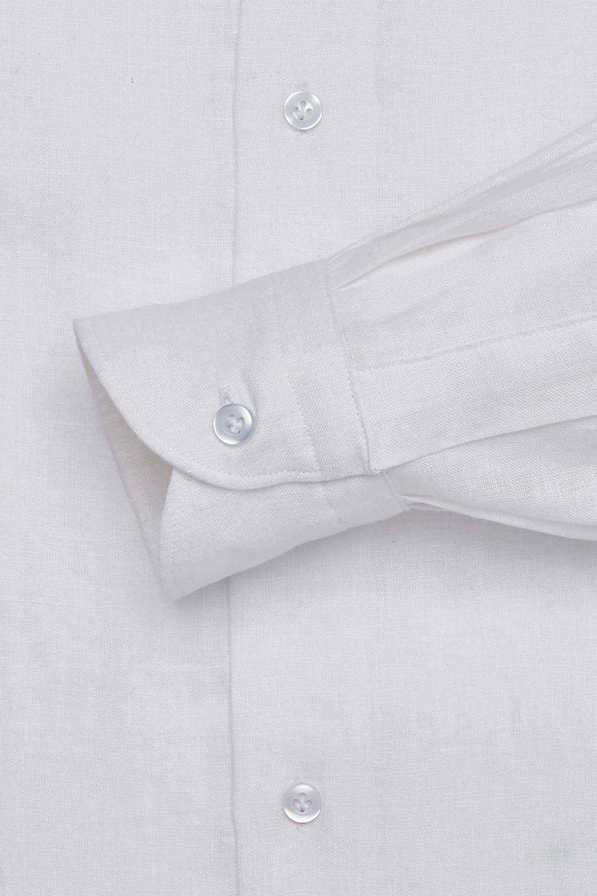 White dress shirt cuff close-up with buttoned sleeve and folded hem