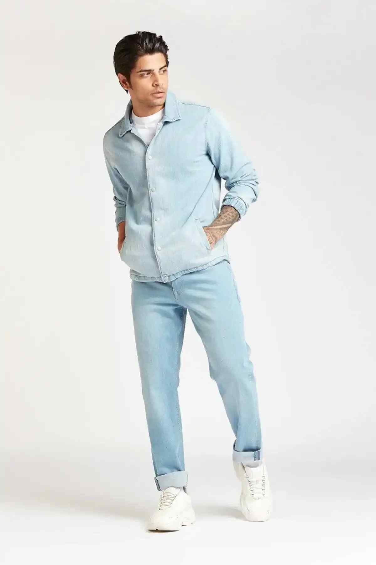 Men's light blue denim button-up shirt and matching jeans, full body