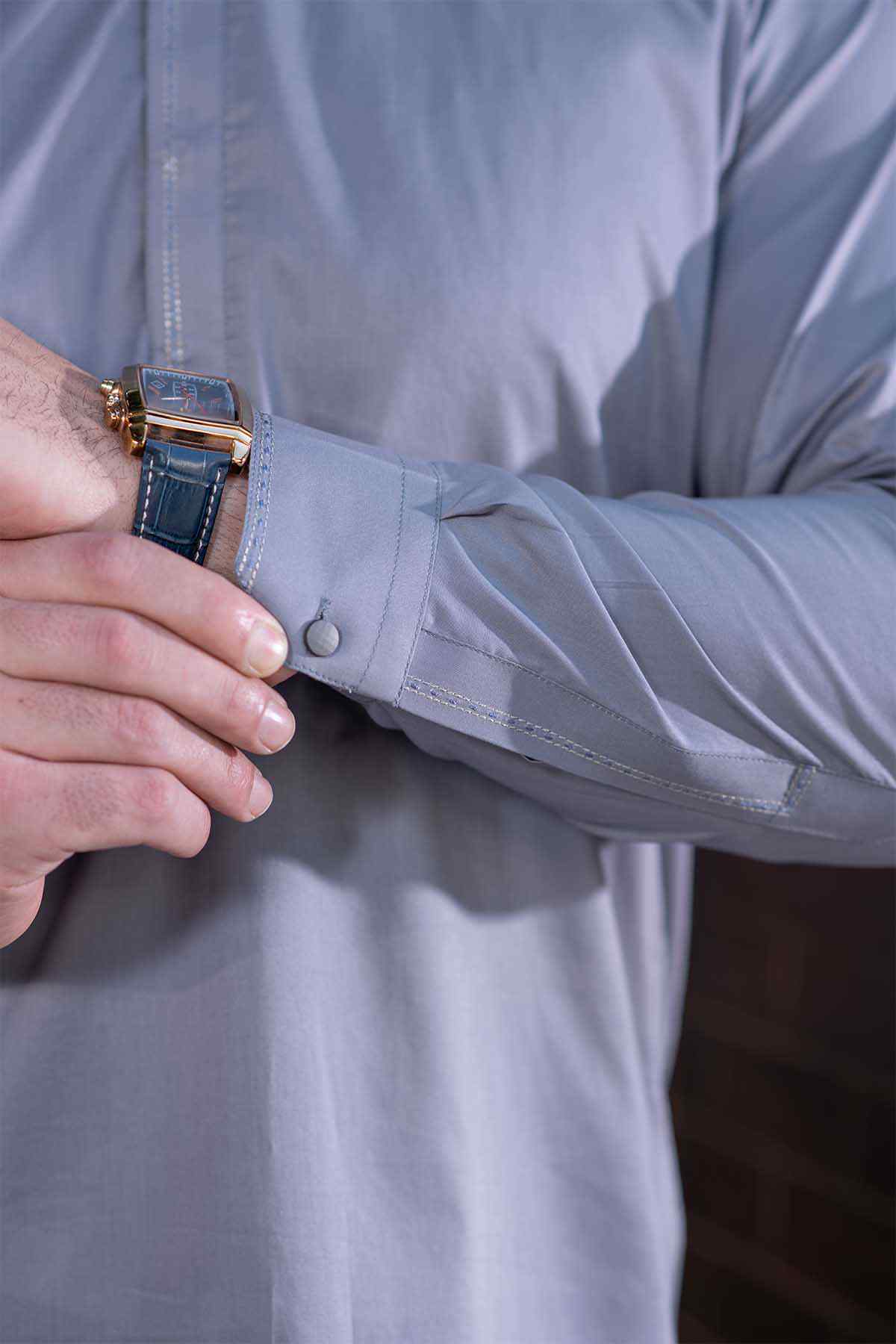 Grey thobe cuff detail with button and sleeve stitching