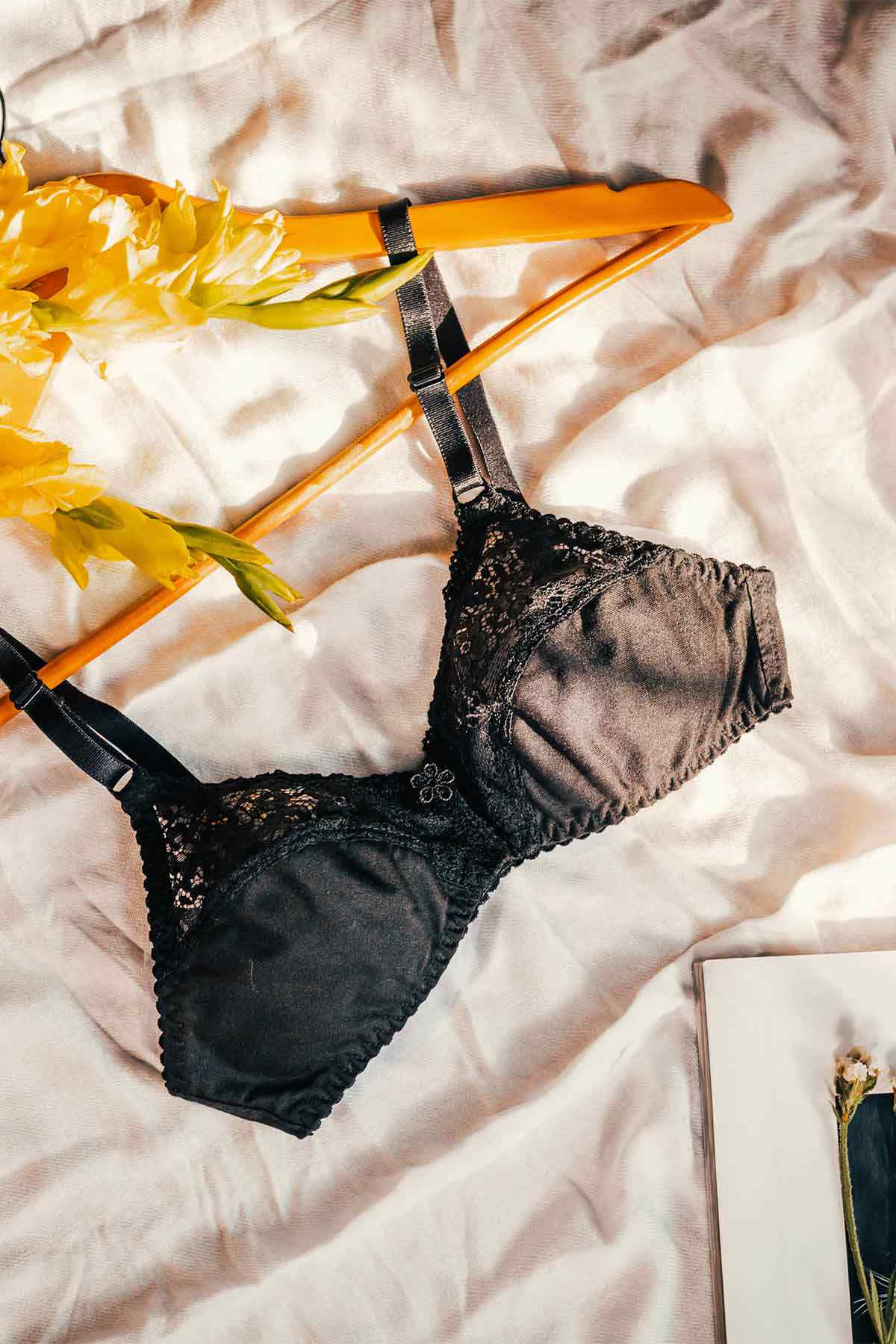 Black lace unpadded bra with underwire and adjustable straps, sheer cups
