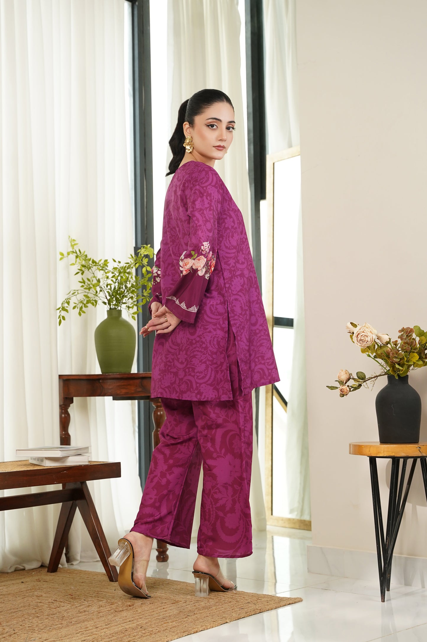 Women's purple kurta and pants set with floral detailing on cuffs and hem