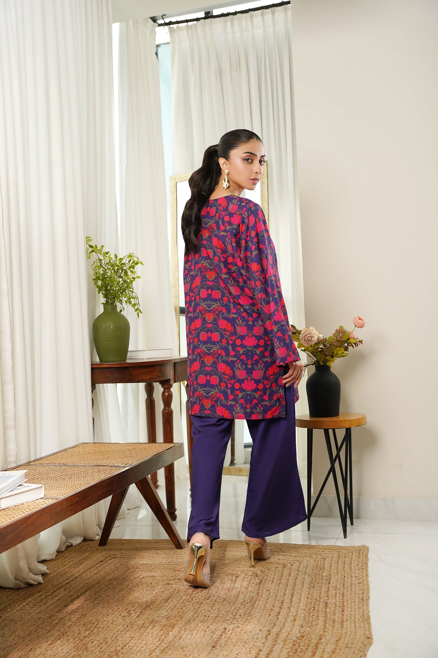 Dhaga red and navy patterned tunic with dark purple wide-leg pants, side view