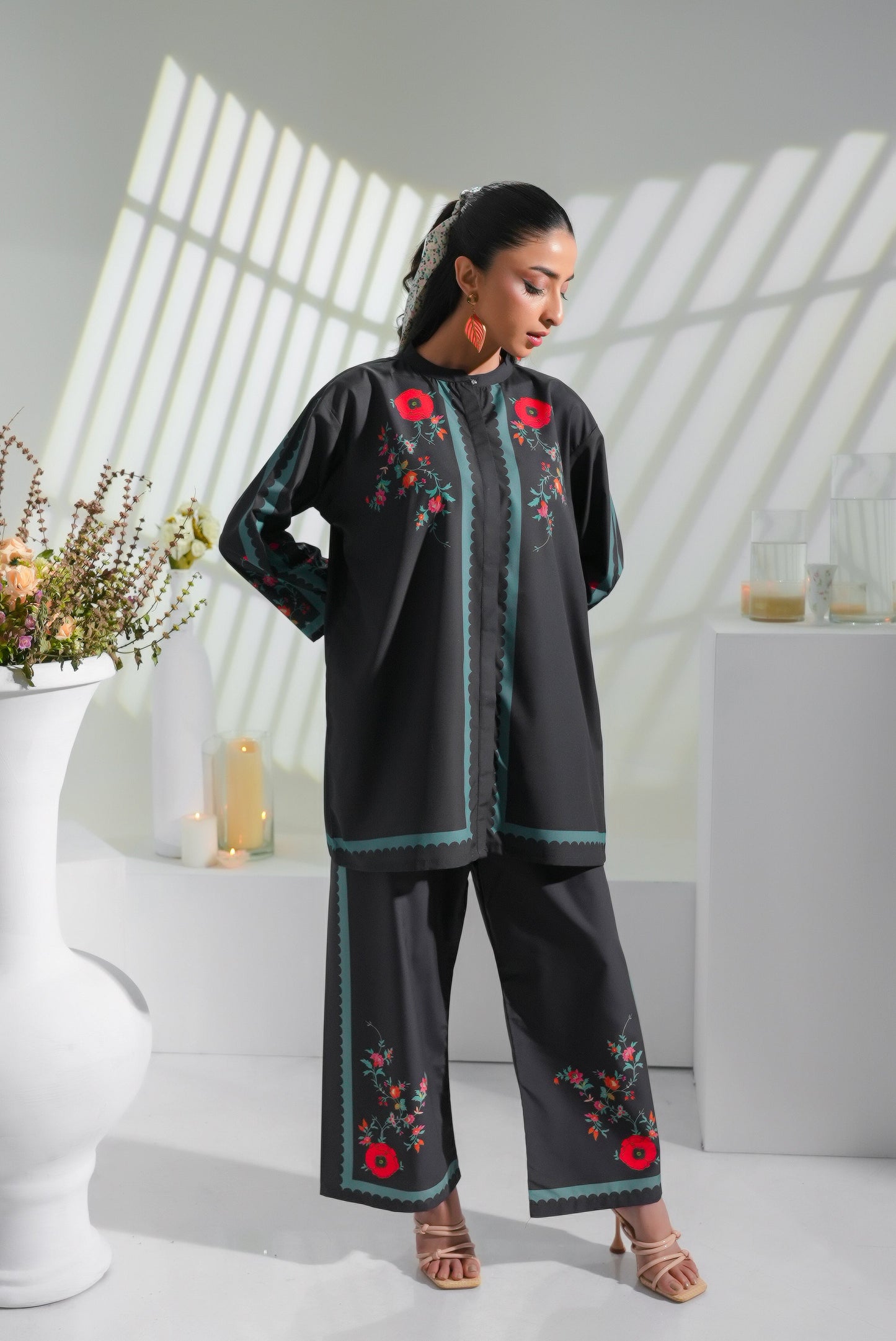 Black embroidered tunic and pants set with red flowers and teal piping along edges