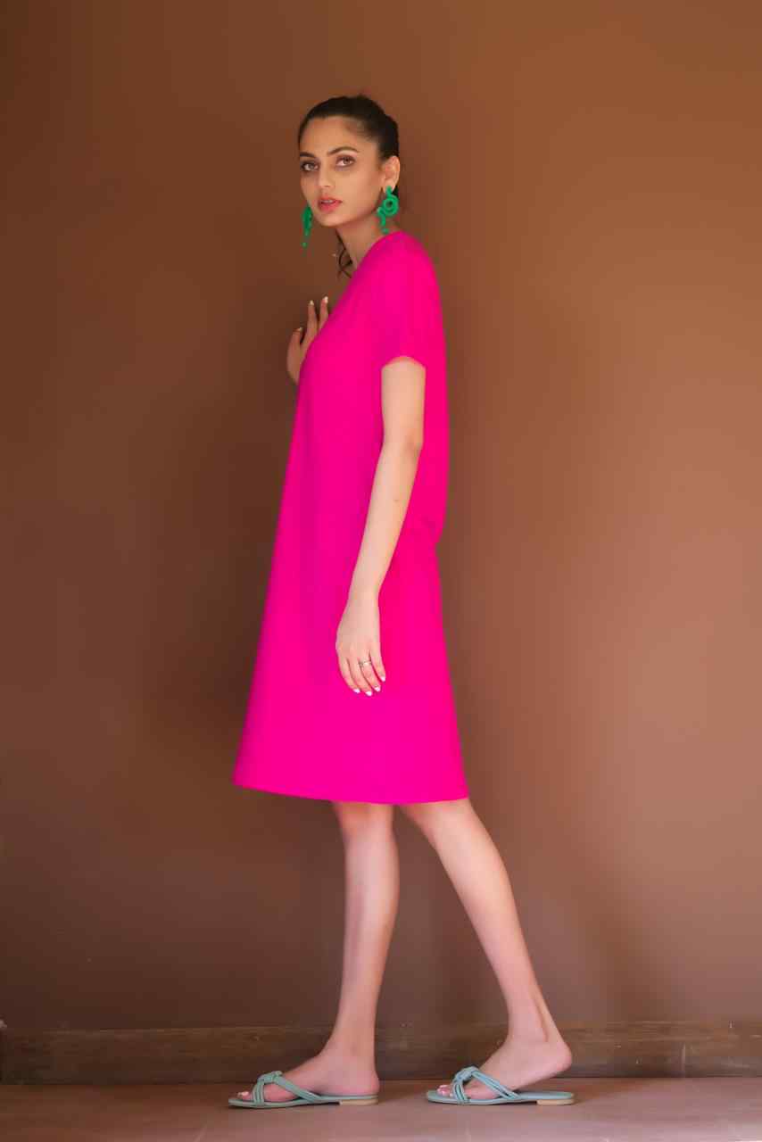 Bright pink crewneck short-sleeve shift dress, side profile with knee-length hem