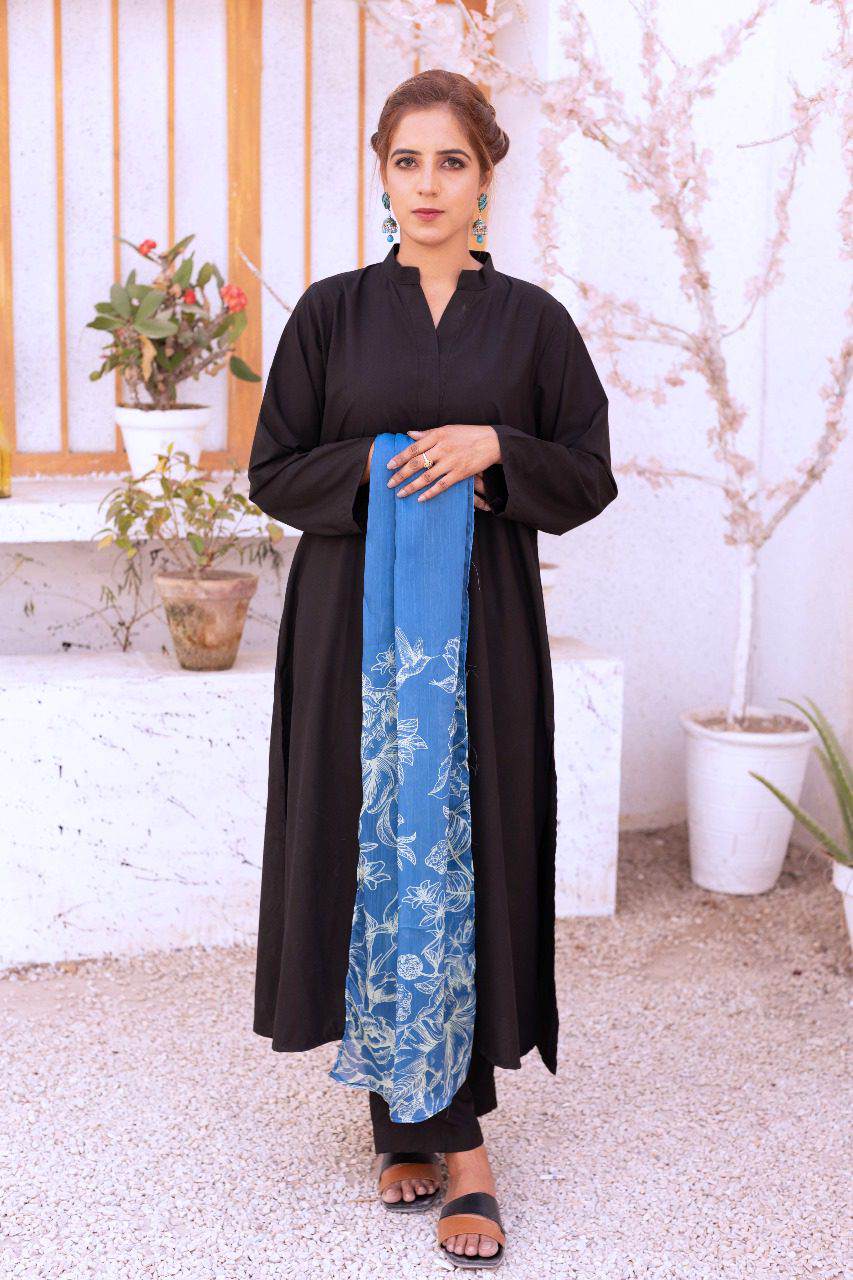 Dhaga long black tunic coat over blue floral maxi dress with leggings