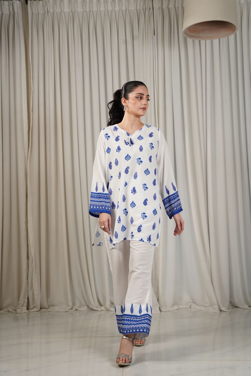 Women’s white kurta with blue border print and matching ankle-length pants set