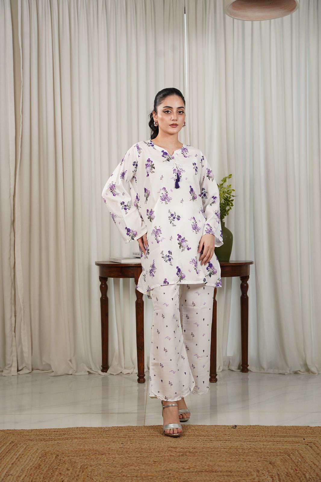 Women’s white floral kurta with wide cuffs and matching slim pants, full body front