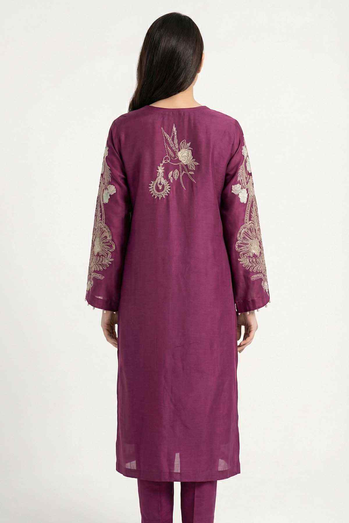 Plum kurta with embroidered back motif and three-quarter sleeves, worn with slim pants.
