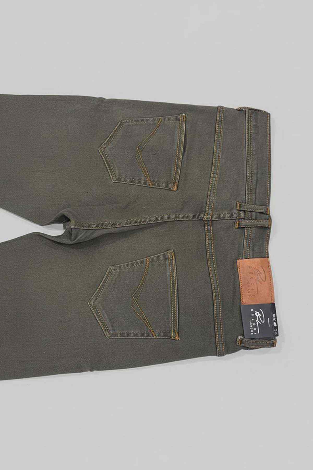 Olive green denim jeans close-up with stitched pockets and hang tag