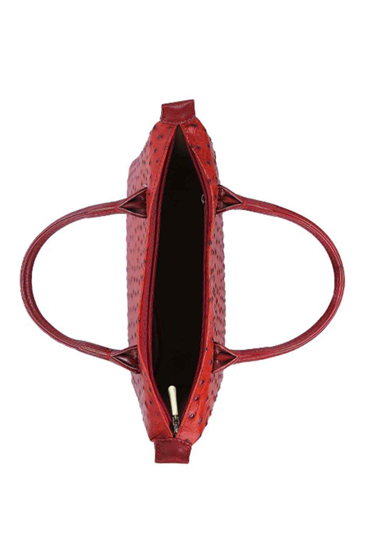 Open crimson red stud-pattern handbag showing interior pocket and lining